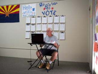 An old man registering to vote in the picture
