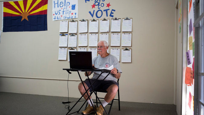 An old man registering to vote in the picture