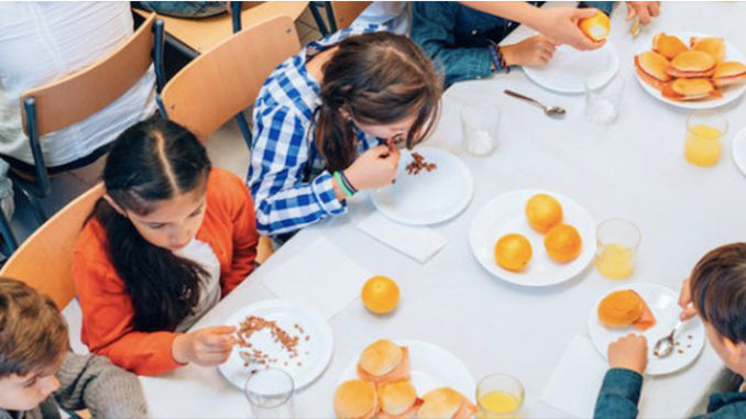 The students having their food on cafeteria