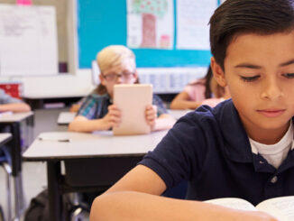 A Latino Boy In School Studying